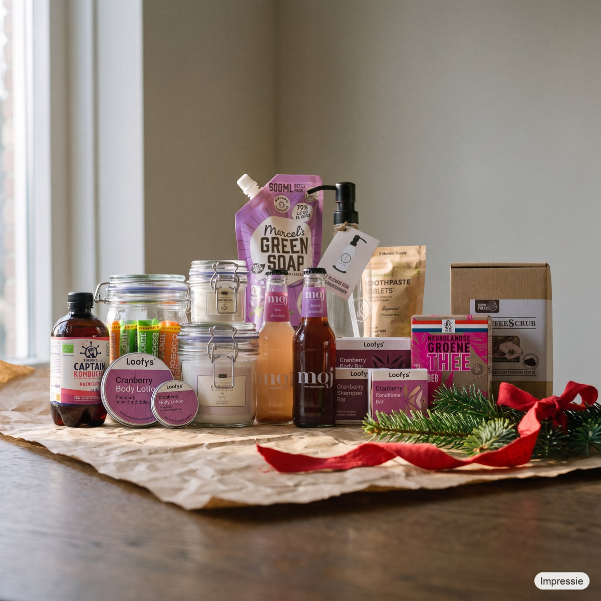 Feel Good Kerstpakket - XL - Paars op een houten tafel met kraftpapier, dennentakken en een rood lint (impressie)
