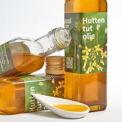Huttentutolie op een lepel, naast flessen van Land van Ons
